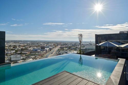 a swimming pool on the roof of a building with a view at Four Points by Sheraton Ciudad Juarez in Ciudad Juárez