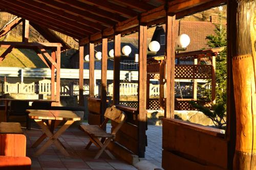a wooden pavilion with a table and chairs on a patio at Fortuna in Lazeshchyna