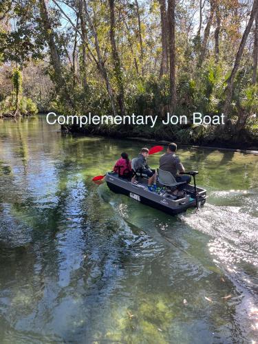 a group of people in a boat on a river at Main River Retreat hot tub, canoe with trolling motor in Spring Hill