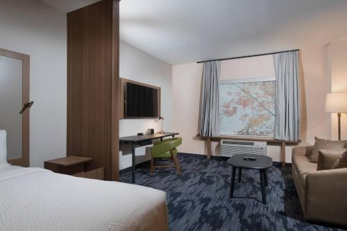 a hotel room with a bed and a desk at Fairfield Inn & Suites by Marriott Tyler South in Tyler