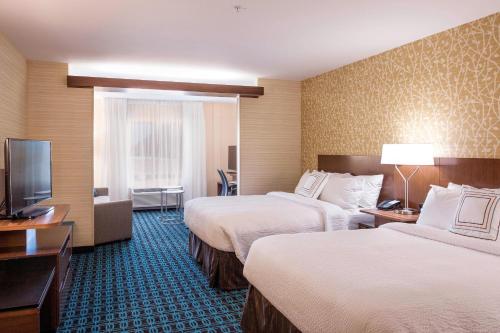 a hotel room with two beds and a flat screen tv at Fairfield Inn & Suites by Marriott Phoenix Tempe/Airport in Tempe