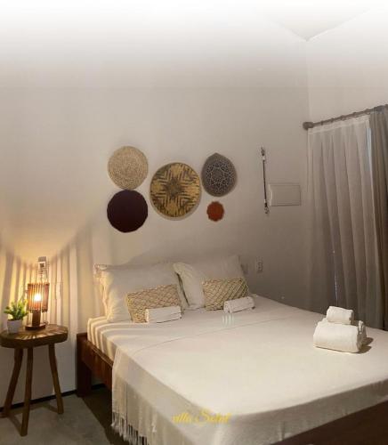 a bedroom with a large white bed in a room at icaraizinho villa soleil in Amontada