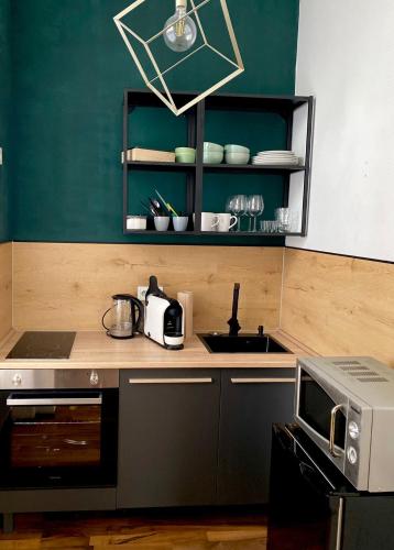 a kitchen with a sink and a microwave at Gemütliches Apartment am Rhein 2 in Koblenz
