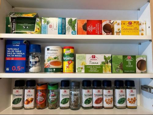 a shelf filled with different types of food items at Comodo appartamento nel cuore dell'Engadina in Celerina
