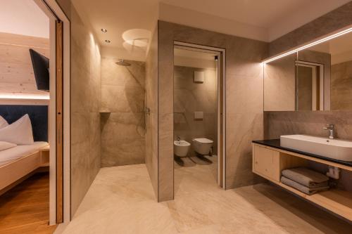 a bathroom with a shower and a sink at A-Lunis in Brunico