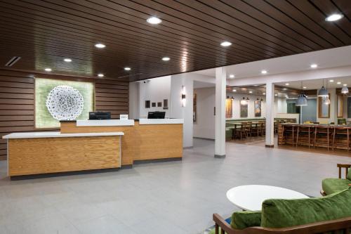 a lobby of a hospital with a reception desk and chairs at Fairfield by Marriott Inn & Suites Pensacola Pine Forest in Pensacola