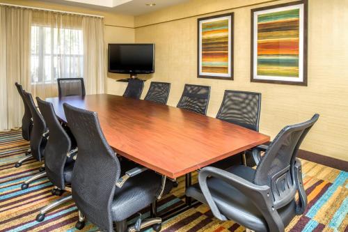 a conference room with a wooden table and chairs at Fairfield Inn & Suites Jacksonville Airport in Jacksonville