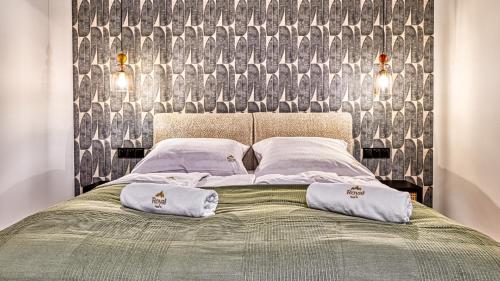 a bedroom with a bed with two pillows on it at Źródło Izery przy gondoli VIP Sauna, Siłownia, Bawialnia by Royal Aparts in Świeradów-Zdrój