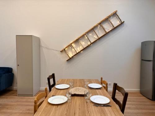 a dining room table with chairs and a light at La Tour en Belledonne in Theys