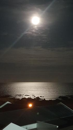 a full moon rising over the water at night at View on the Bay 7 Pinta Crescent in St Helena Bay
