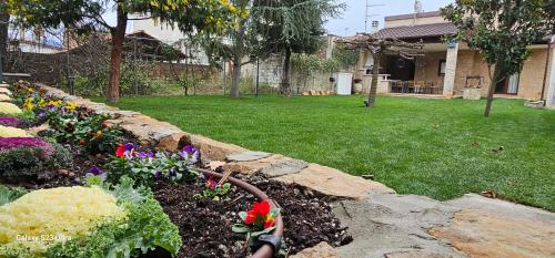 a garden with flowers in a rock wall at Garden's House Pozar in Aridaia in Aridaia