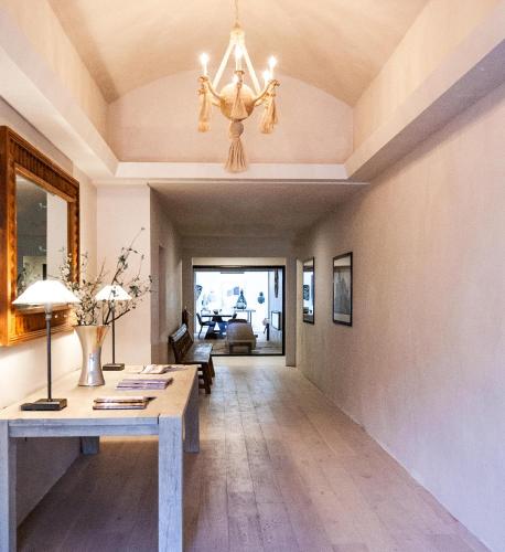 a living room with a table and a chandelier at Palace Modern Hotel at the Plaza in Santa Fe