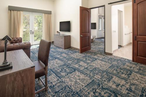 a living room with a couch and a television at Four Points by Sheraton Santa Cruz Scotts Valley in Scotts Valley