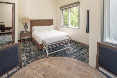 a bedroom with a bed and a window and a table at Four Points by Sheraton Santa Cruz Scotts Valley in Scotts Valley