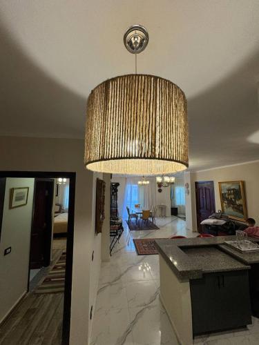 a large chandelier hanging from the ceiling of a living room at Compound Canarya - 3 Bedroom Apartment in 6th Of October