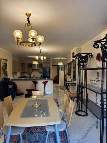 a dining room and living room with a table and chairs at Compound Canarya - 3 Bedroom Apartment in 6th Of October