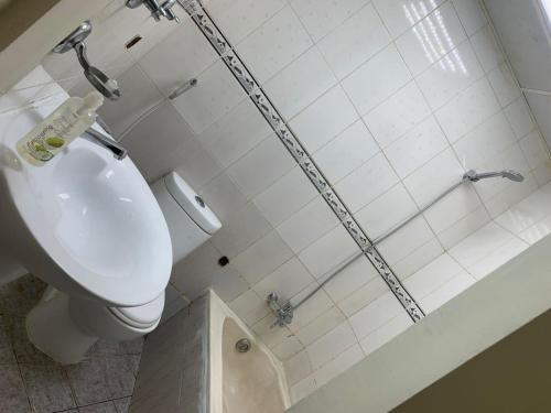 a bathroom with a shower with a toilet and a sink at SHJ DXB Sunny Border Guesthouse in Dubai