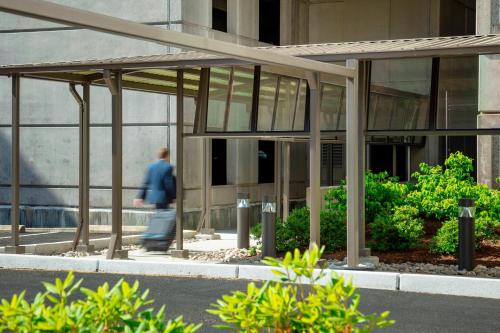 a man walking in front of a building at Fairfield Inn & Suites by Marriott Providence Airport Warwick in Warwick