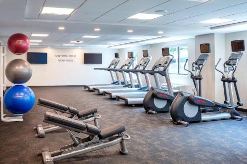 a gym with a row of treadms and cardio machines at Fairfield Inn & Suites by Marriott Providence Airport Warwick in Warwick