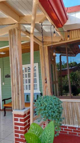 a porch with columns and a bench on a house at La Casona don Miguel in San Marcos