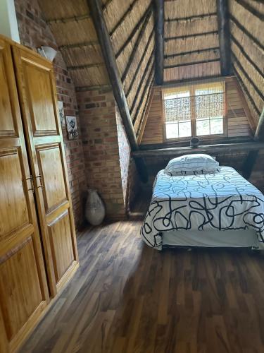 a bedroom with a bed in an attic at Okgethilwe Lodge in Sabie