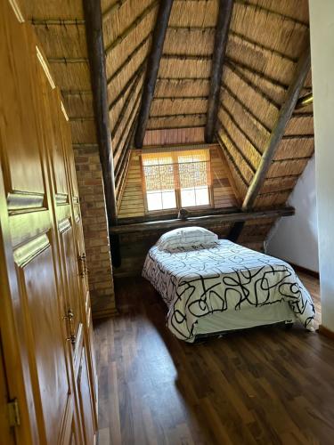 a bedroom with a bed in a attic at Okgethilwe Lodge in Sabie