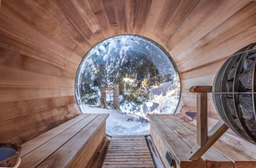 an inside view of a sauna with a round window at Chalet Octopussy - LES GETS, jacuzzi, sauna, superbe vue in Les Gets