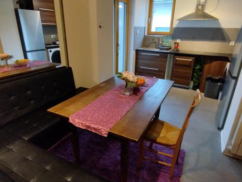 a kitchen with a wooden table with flowers on it at Sandrina in Zagreb
