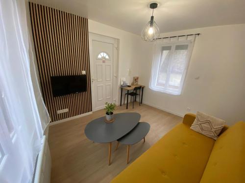 a living room with a couch and a table at Appartements Pacy-sur-Eure in Pacy-sur-Eure
