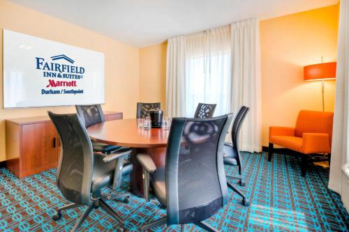 a hotel room with a table and chairs at Fairfield Inn and Suites by Marriott Durham Southpoint in Durham