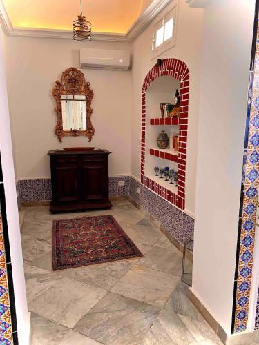 a hallway with a room with a mirror and a rug at Dar Saida in Sidi Bou Saïd