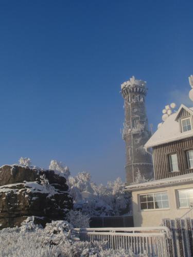 a house with a tower in the snow at Sněžník in Sněžnik