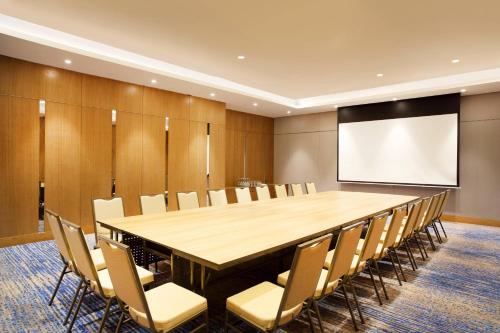 a conference room with a large table and chairs at Four Points by Sheraton Surabaya, Tunjungan Plaza in Surabaya
