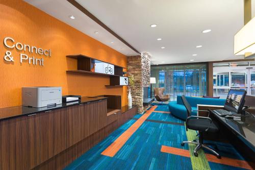 an office with a reception desk and a sign that reads connect and print at Fairfield Inn & Suites by Marriott Belle Vernon in Belle Vernon