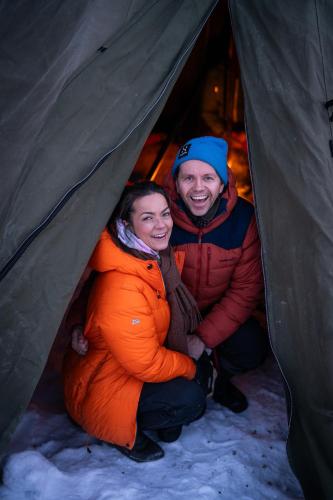 a man and woman sitting inside of a tent at ONGA Boutique Lodge in Alta