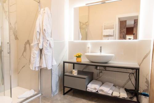 a bathroom with a sink and a mirror at Adelaide Suite Dreams in Rome