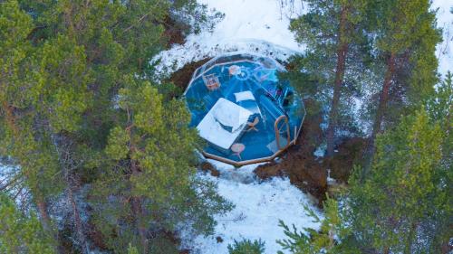 an overhead view of a blue boat in the woods at ONGA Boutique Lodge in Alta