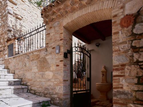 an entrance to a stone building with an iron gate at Il Cortiletto del Borgo in Pietra Montecorvino