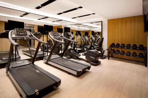 a gym with several treadmills and elliptical machines at Fairfield by Marriott Busan in Busan