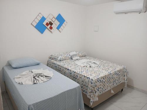Postel nebo postele na pokoji v ubytování Suite Pajuçara