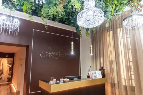 a store with chandeliers and a counter in a room at Adelaide Suite Dreams in Rome