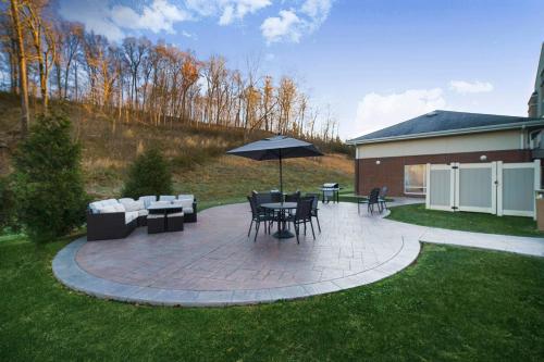 a patio with a table and chairs and an umbrella at Fairfield Inn & Suites by Marriott Marietta in Marietta