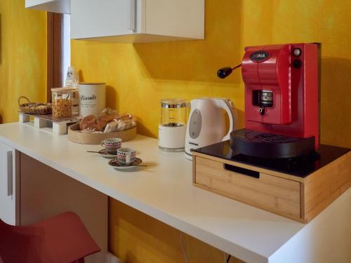 a kitchen with a red coffee maker on a counter at Il Cortiletto del Borgo in Pietra Montecorvino
