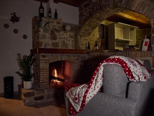 a living room with a couch and a fireplace at Il Cortiletto del Borgo in Pietra Montecorvino