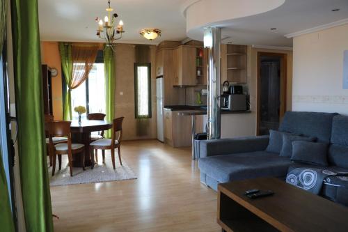 a living room with a couch and a dining room at La dama del mar in Punta Prima