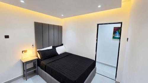 a small bedroom with a bed and a glass door at Oasis Moods Holiday Homes in Al Ain