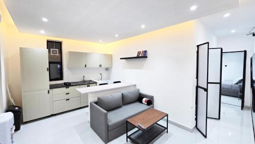 a kitchen with a couch and a table in a room at Oasis Moods Holiday Homes in Al Ain