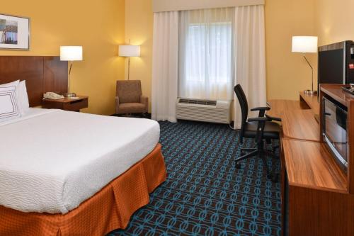 a hotel room with a bed and a television at Fairfield Inn Jacksonville Orange Park in Orange Park
