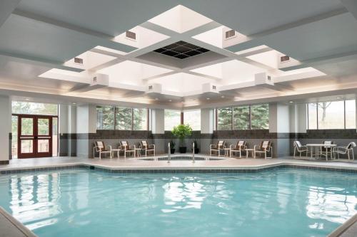 a large pool with chairs and tables in a building at Colorado Springs Marriott in Colorado Springs