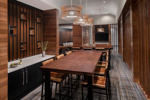 a dining room with a large wooden table and chairs at Cleveland Marriott East in Warrensville Heights